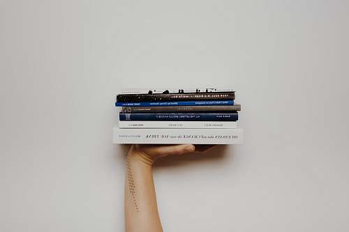electrical device person holding pile of books connector
